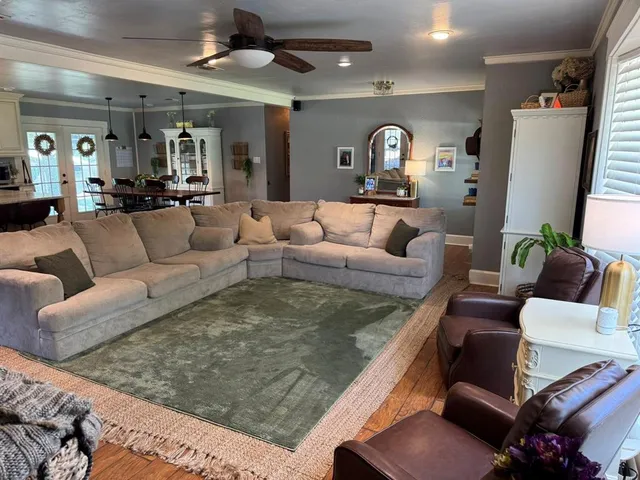 a living room with furniture and a large mirror