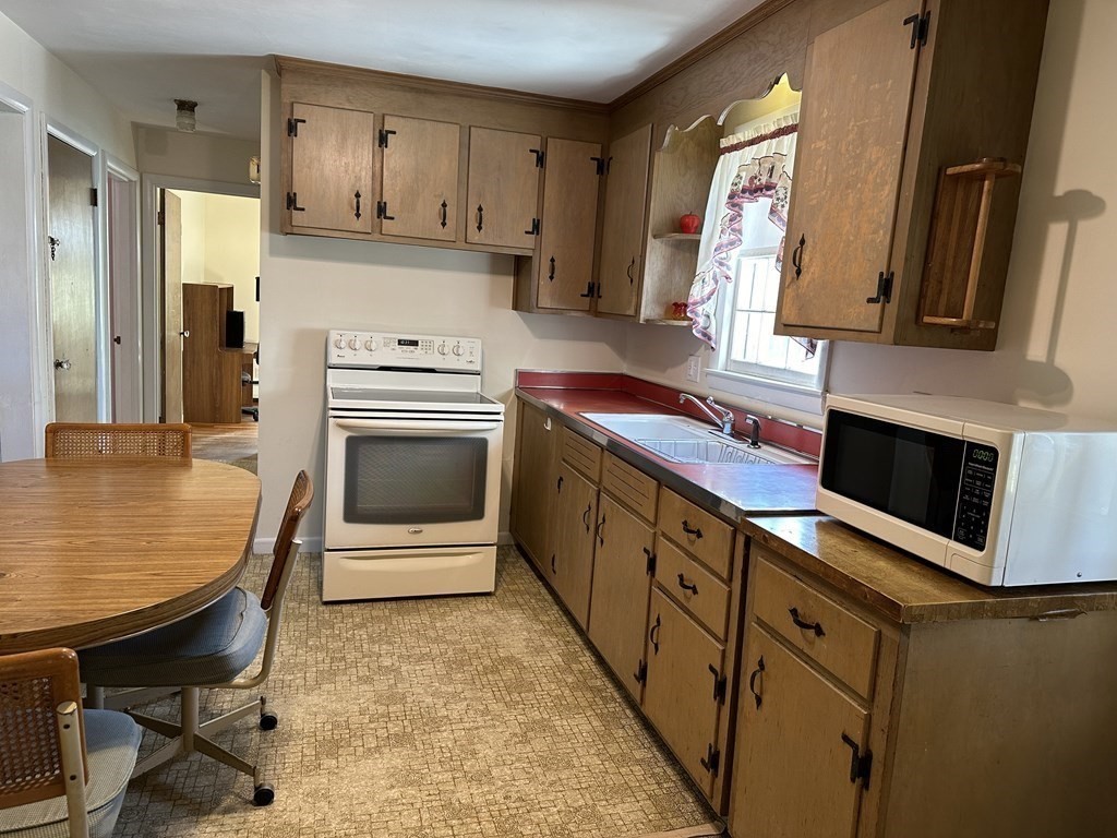 51 Prudential Road Worcester, MA 01606 - Photo 15 of 26 a kitchen with stainless steel appliances granite countertop a stove a sink and a refrigerator