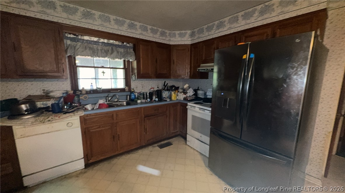 7939 Clinton Road Stedman, NC 28391 - Photo 13 of 50 a kitchen with stainless steel appliances granite countertop a refrigerator and a sink