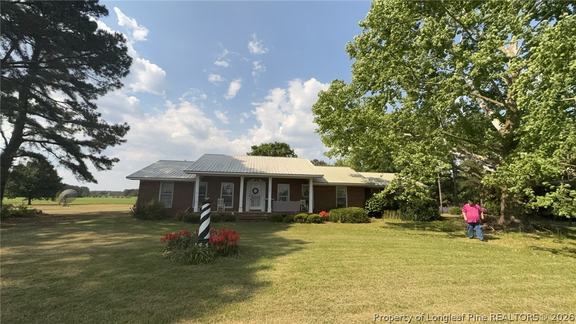 7939 Clinton Road Stedman, NC 28391 - Photo 2 of 50 a front view of a house with garden