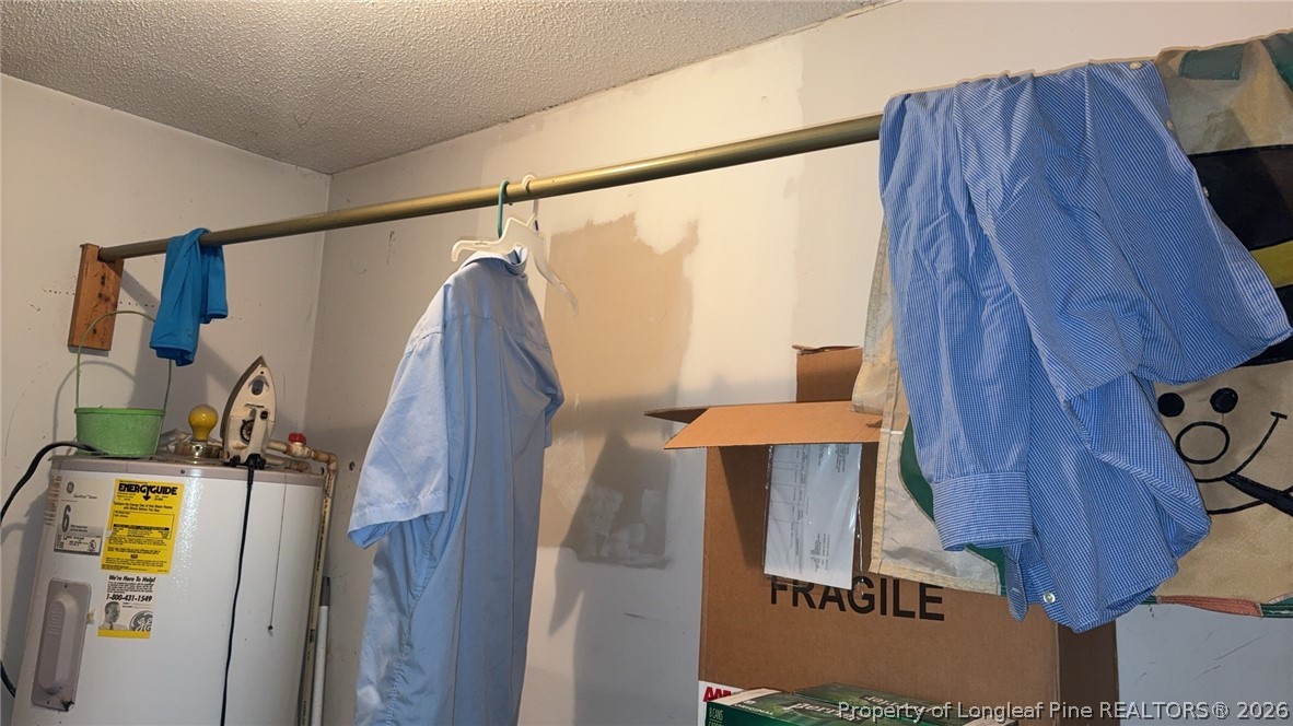 7939 Clinton Road Stedman, NC 28391 - Photo 30 of 50 a view of walk in closet with clothes and shoes