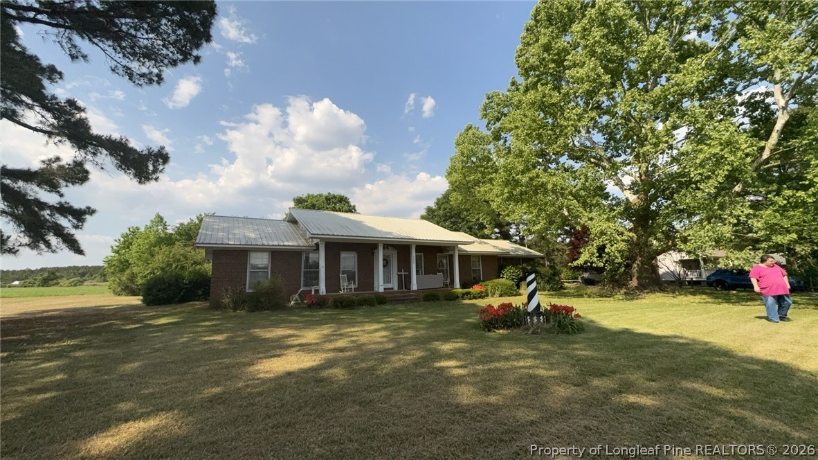 7939 Clinton Road Stedman, NC 28391 - Photo 4 of 50 a view of a house with a yard porch and sitting area