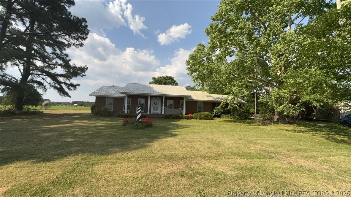 7939 Clinton Road Stedman, NC 28391 - Photo 5 of 50 a backyard of a house with table and chairs