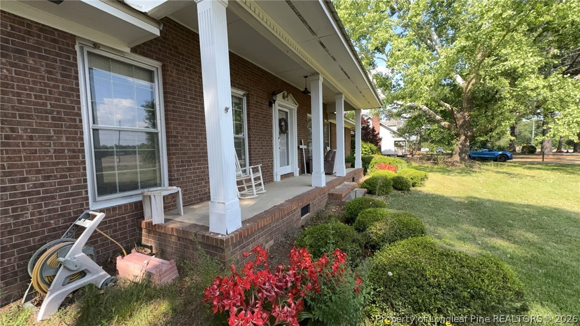 7939 Clinton Road Stedman, NC 28391 - Photo 7 of 50 a view of a patio with table and chairs and potted plants