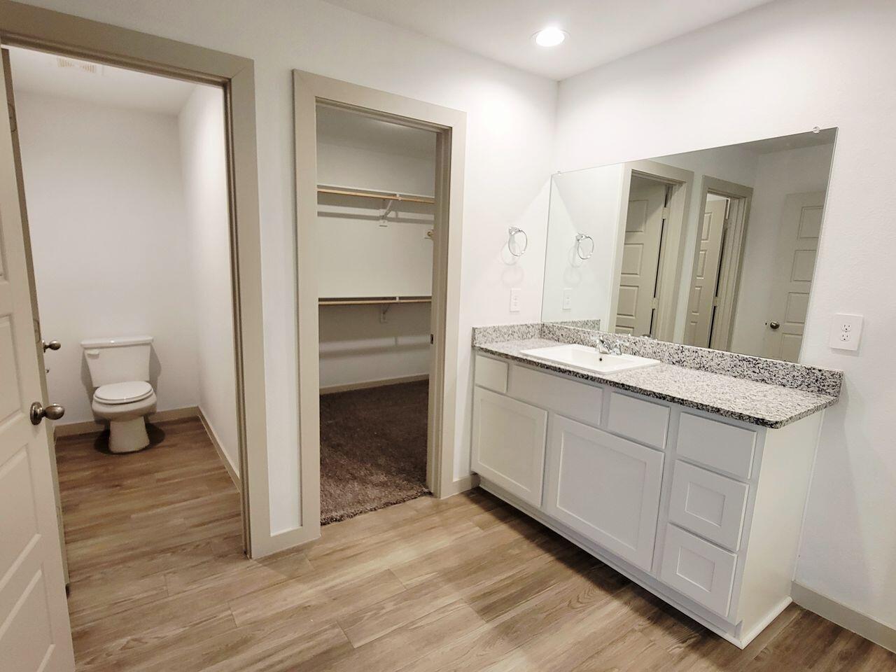 7324 9th Street Lubbock, TX 79416 - Photo 16 of 21 a bathroom with a double vanity sink and a mirror