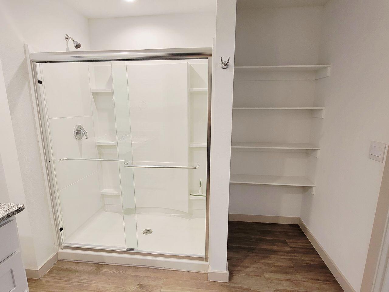 7324 9th Street Lubbock, TX 79416 - Photo 18 of 21 a bathroom with a glass shower door