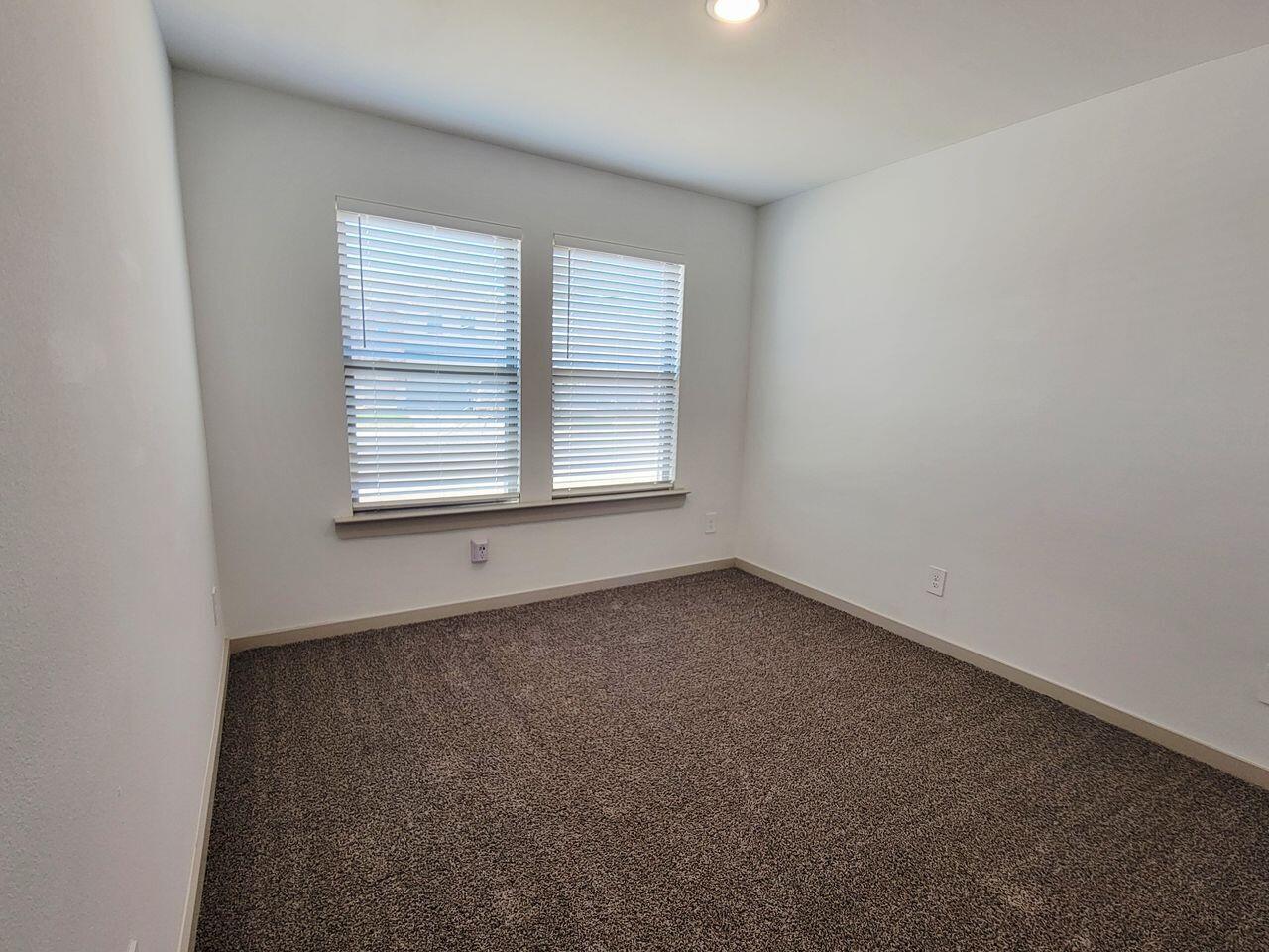7324 9th Street Lubbock, TX 79416 - Photo 9 of 21 an empty room with a window