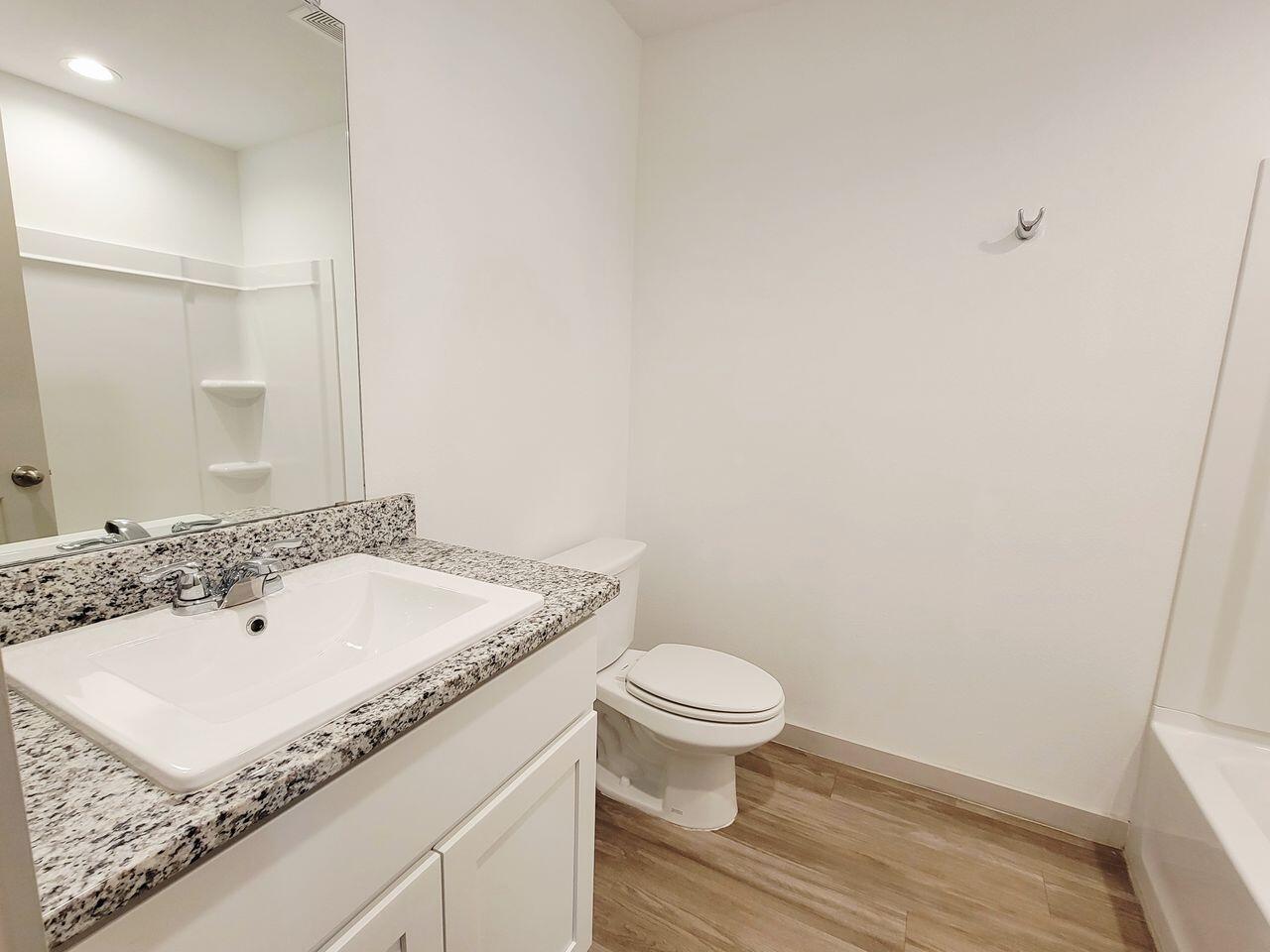 7324 9th Street Lubbock, TX 79416 - Photo 10 of 21 a bathroom with a sink and a toilet