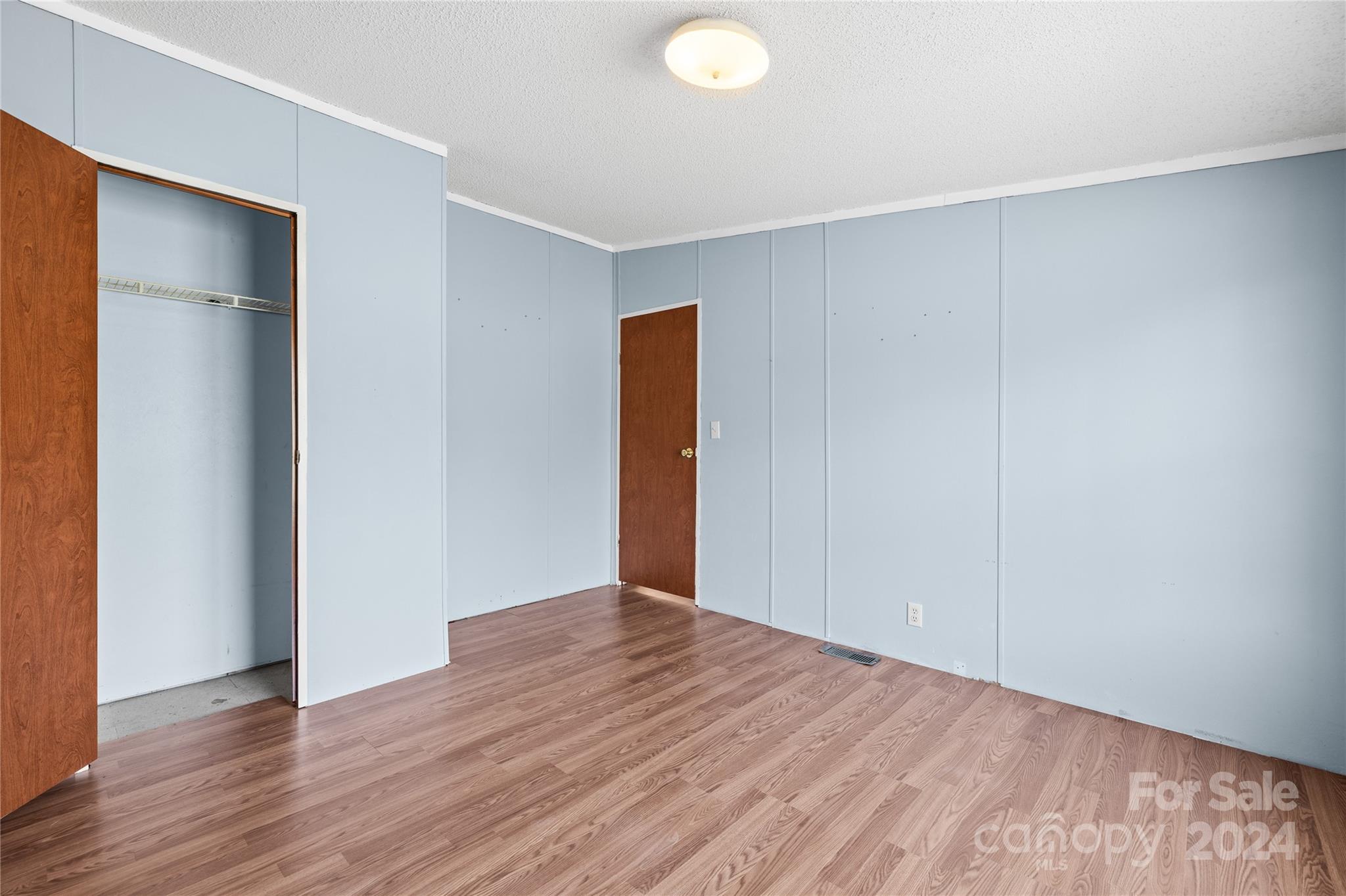 436 Beth Haven Church Road Denver, NC 28037 - Photo 21 of 32 an empty room with wooden floor and closet