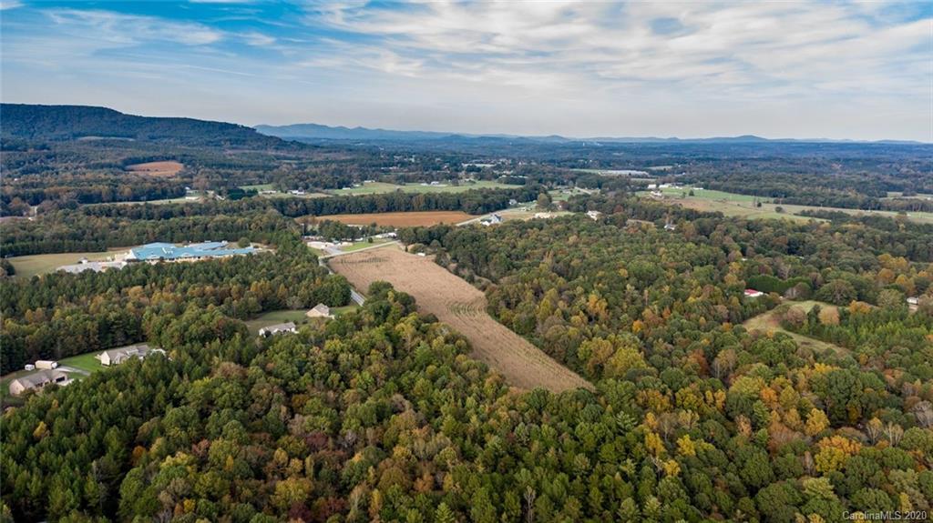 7241 Church Road Taylorsville, NC 28681 - Photo 6 of 27 an aerial view of residential houses with outdoor space and trees