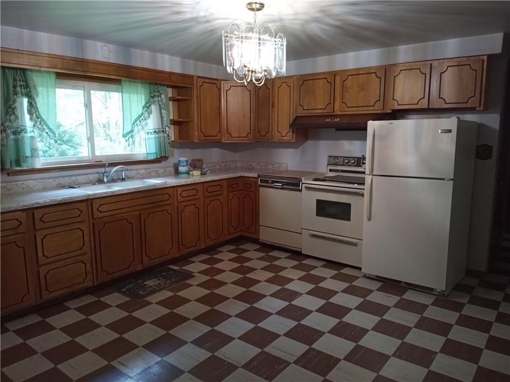 3292 Georgetown Road Polk, PA 16342 - Photo 13 of 24 a kitchen with stainless steel appliances granite countertop a sink stove and refrigerator