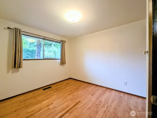 a bathroom with a granite countertop sink a large mirror and toilet
