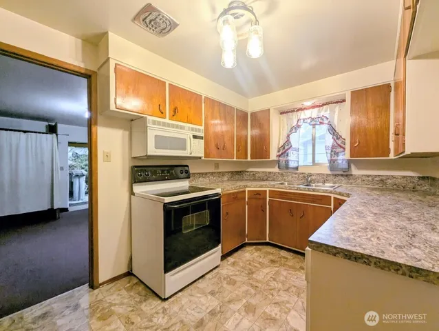 a kitchen with stainless steel appliances granite countertop a stove and a sink