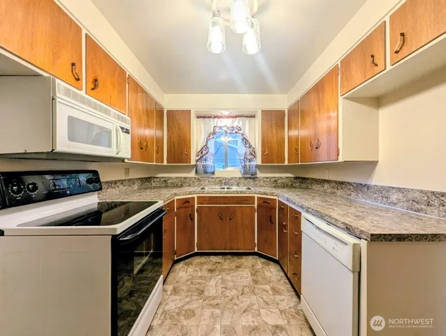 a kitchen with a stove sink and cabinets