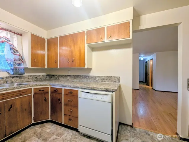 a kitchen with a stove a sink and a refrigerator