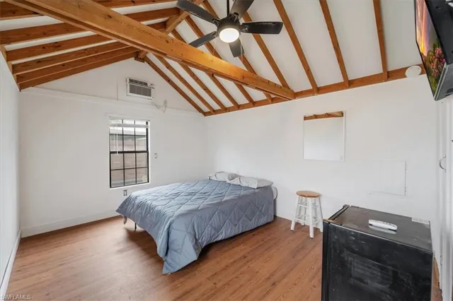 a bedroom with a bed and a ceiling fan