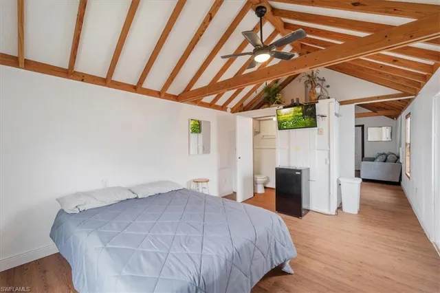 a bedroom with a bed and a tv