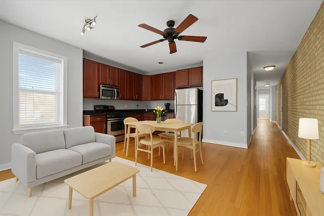 a living room with furniture a dining table and kitchen view