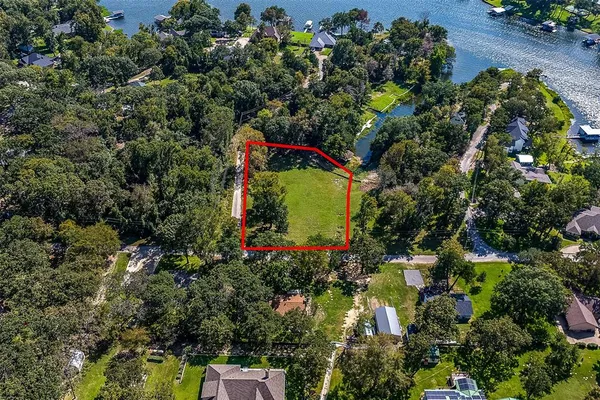 an aerial view of a house with a yard and garden