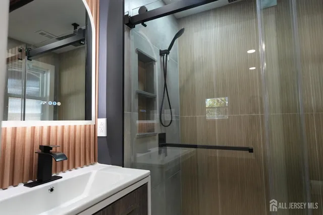 a bathroom with a shower and a sink