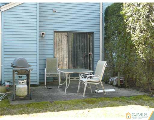 1105 Timber Oaks Road Edison, NJ 08820 - Photo 22 of 22 a building outdoor space with a table and chairs