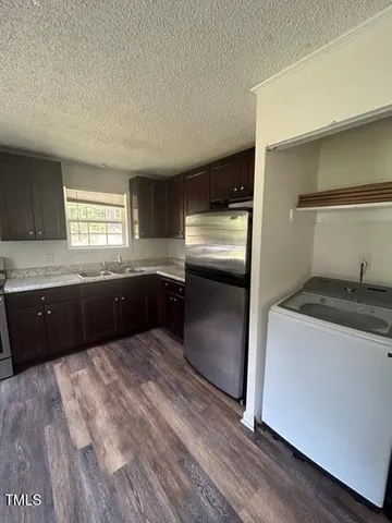 a large kitchen with a stove and a refrigerator
