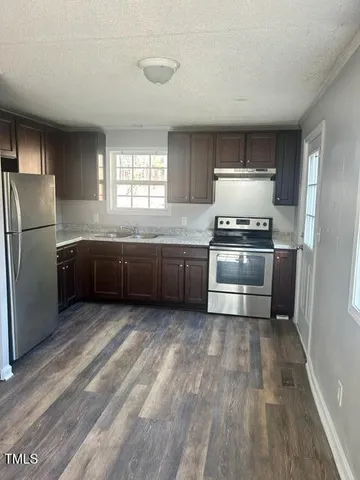 a kitchen with wooden cabinets and stainless steel appliances