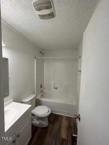 a bathroom with a toilet a sink and shower