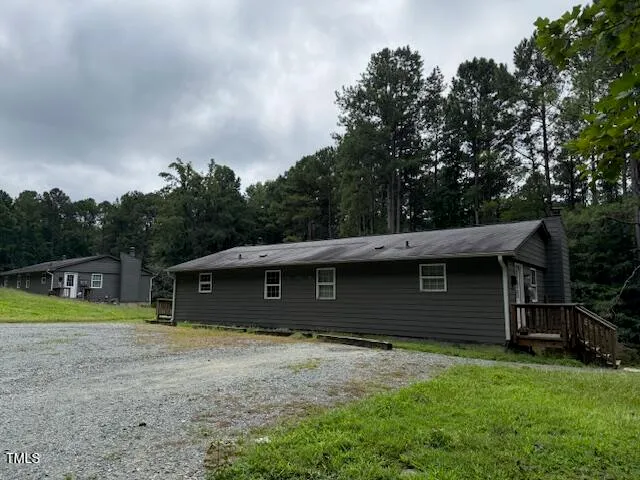 a view of a house with a backyard
