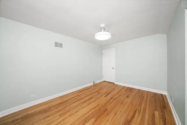 a view of a room with wooden floor and white walls