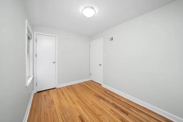 a view of room with wooden floor