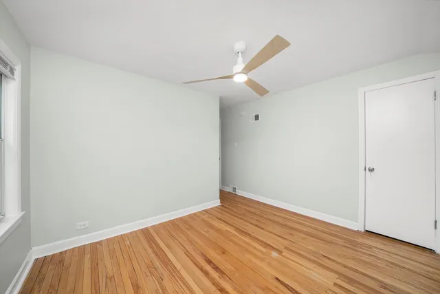 a view of room with wooden floor and white walls