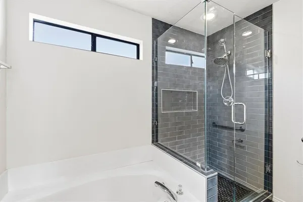 a bathroom with a shower and a sink