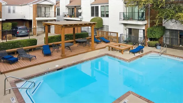 a view of a house with pool and chairs