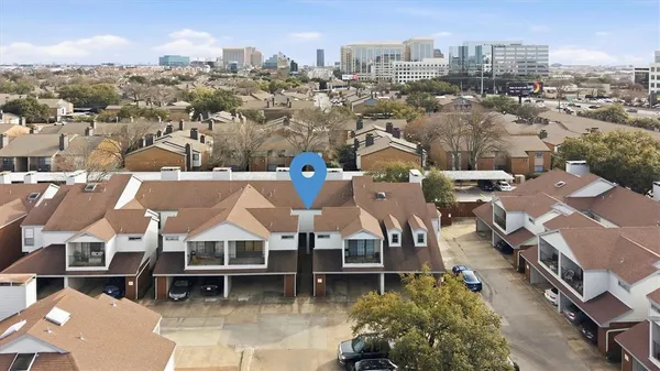 an aerial view of a house with a mountain