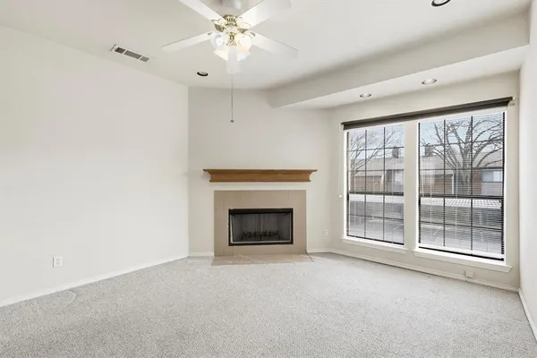 a view of an empty room with a fireplace