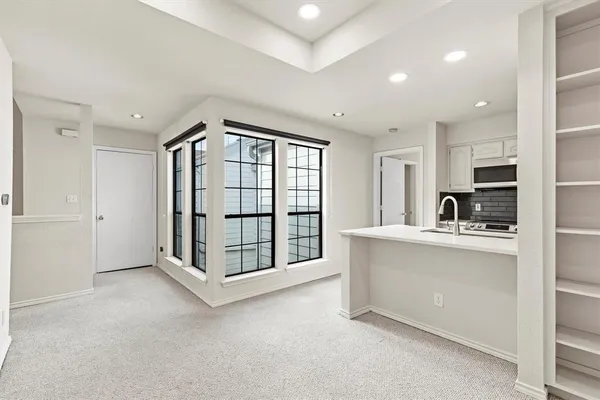a view of kitchen with windows and dual sink