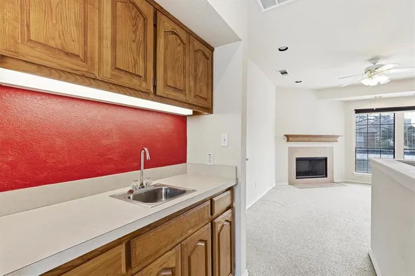 a kitchen with a sink cabinets and a fireplace
