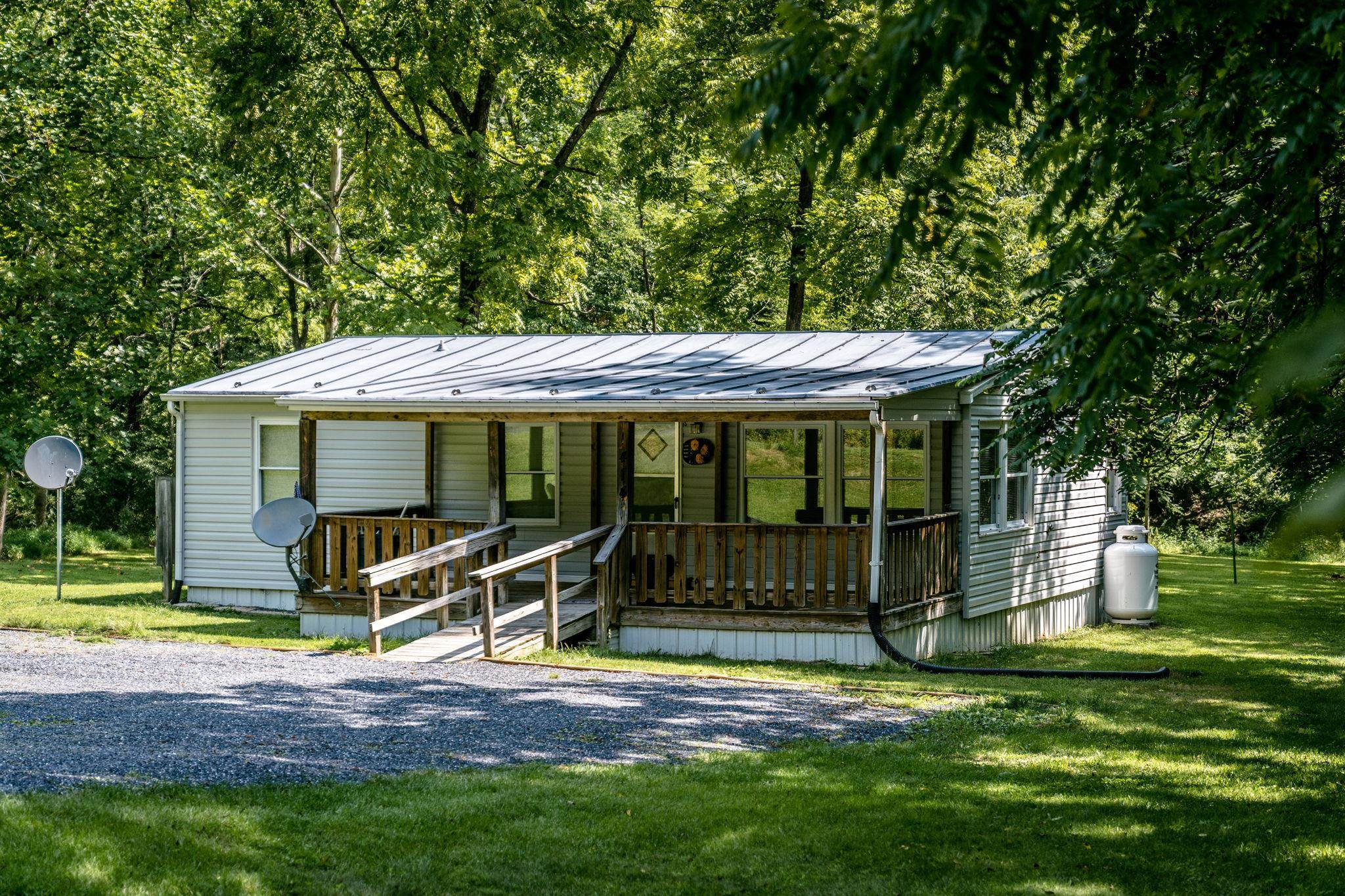 414 Bear Trap Farm Road Mount Solon, VA 22843 - Photo 1 of 40 a view of a house with backyard porch and sitting area