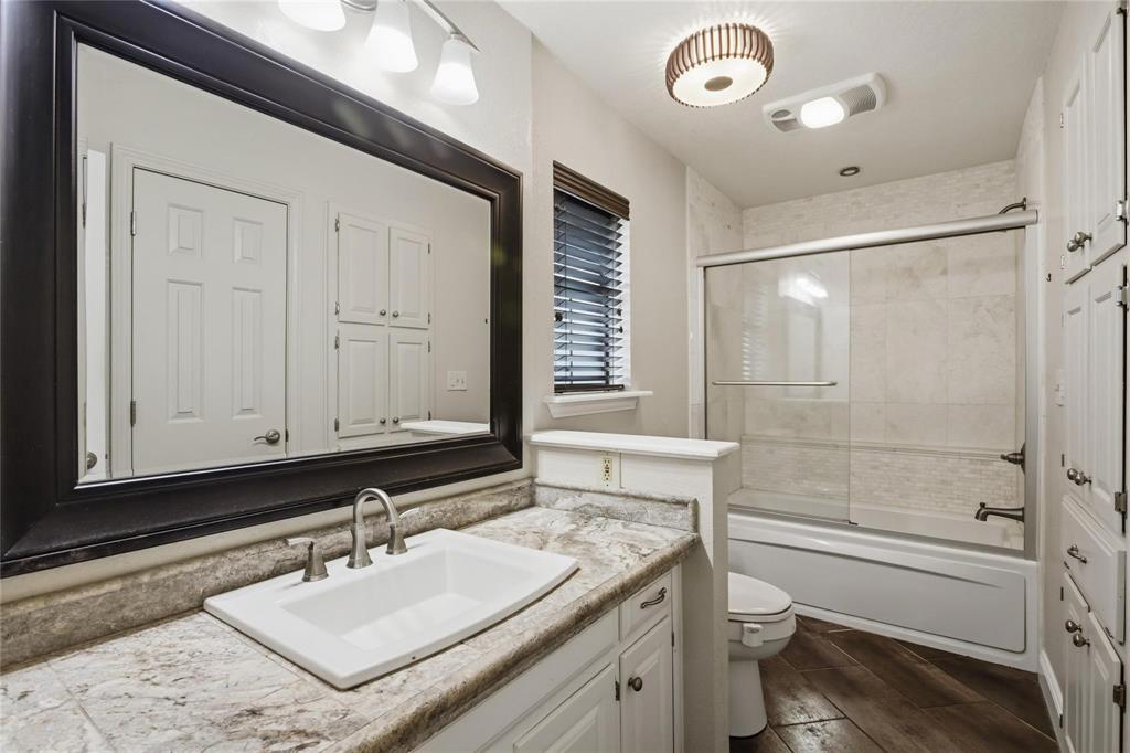 265 East Dove Road Southlake, TX 76092 - Photo 25 of 39 a bathroom with a sink vanity granite toilet and a mirror