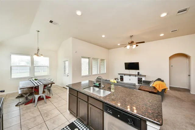 a view of living room with granite countertop furniture and a flat screen tv
