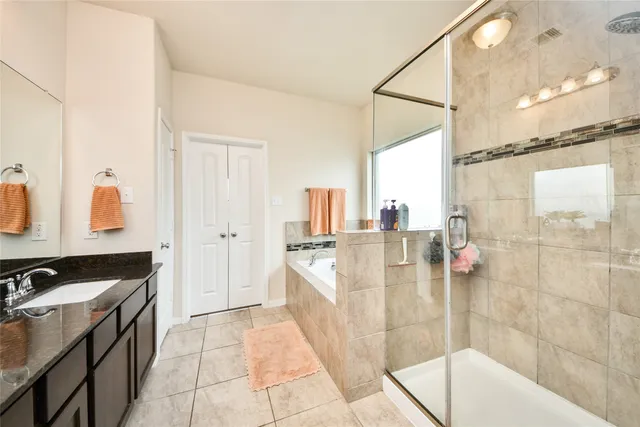 a bathroom with a tub sink and mirror