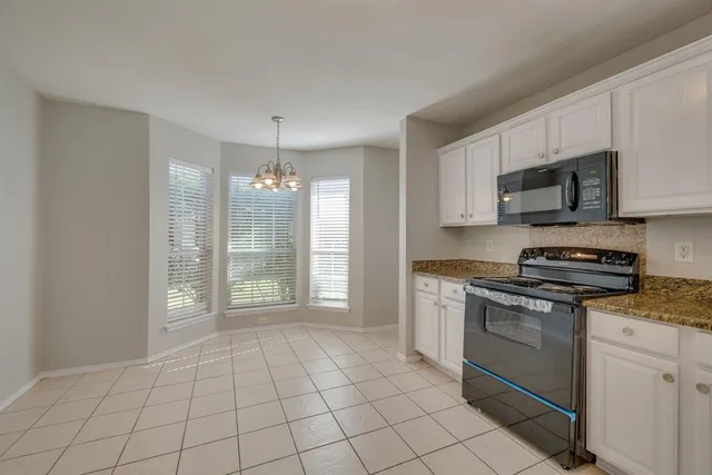a view of a kitchen with microwave and cabinets