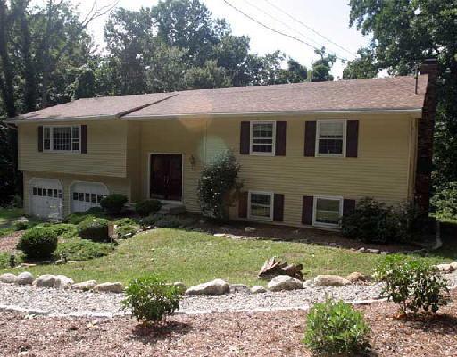 101 Captain Wooster Road Oxford, CT 06478 - Photo 1 of 1 a view of a white house with a yard plants and large tree