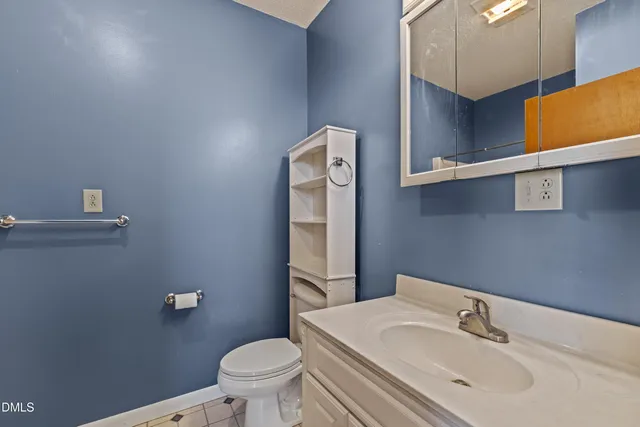 a bathroom with a sink a toilet and mirror