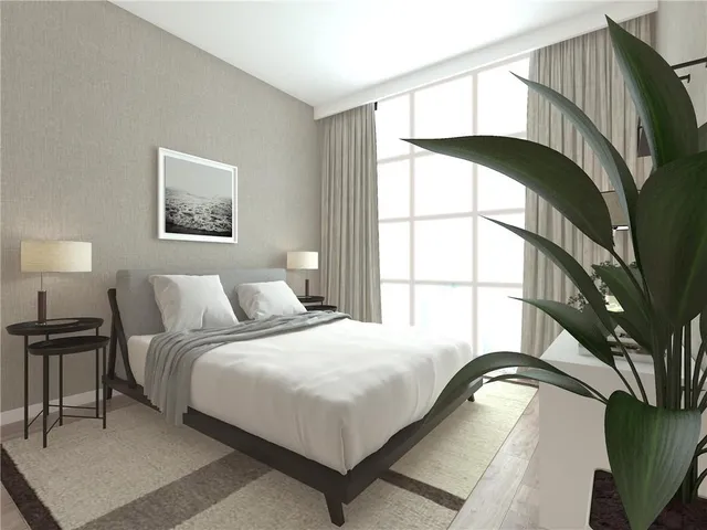 a bedroom with a bed and a painting on the wall