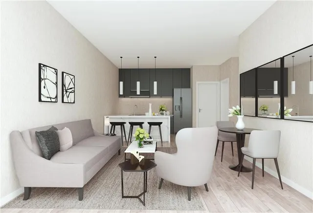 a living room with furniture and a dining table with kitchen view