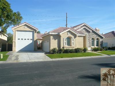 49590 Lewis Road Indio, CA 92201 - Photo 1 of 20 a front view of a house with a yard and garage