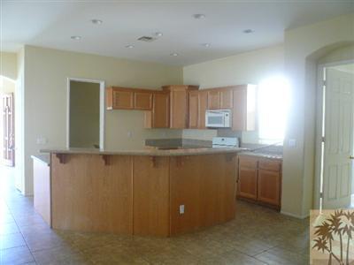 49590 Lewis Road Indio, CA 92201 - Photo 5 of 20 a kitchen with cabinets and window