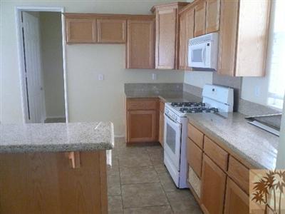 49590 Lewis Road Indio, CA 92201 - Photo 6 of 20 a kitchen with stainless steel appliances granite countertop a sink stove and cabinets